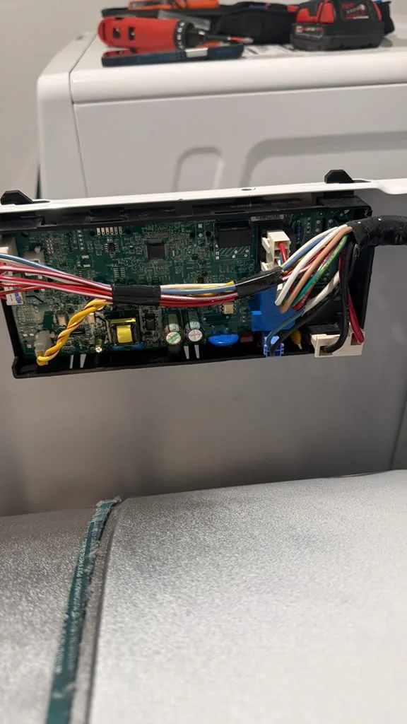 Appliance electronic control board being inspected