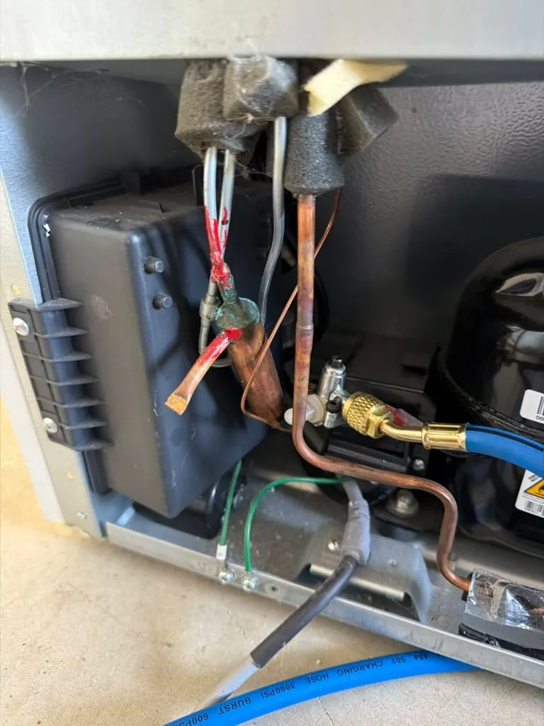 Refrigeration system connected to gauges near the compressor